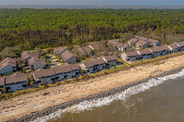 birds eye view of property featuring a beach view and a water view