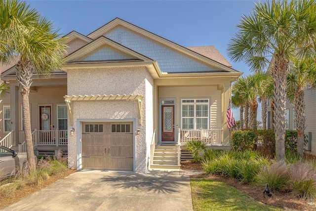 view of front of house with covered porch and a garage