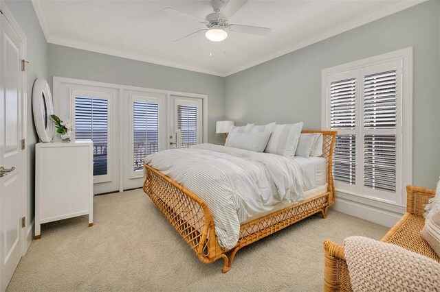 carpeted bedroom with access to exterior, ceiling fan, and ornamental molding