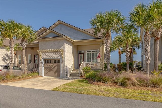 view of front of home featuring covered porch and a garage