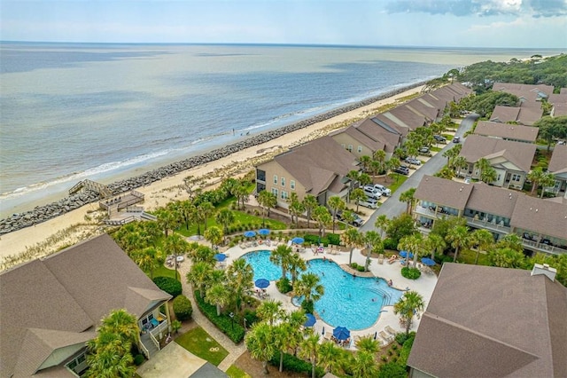 drone / aerial view with a water view and a beach view