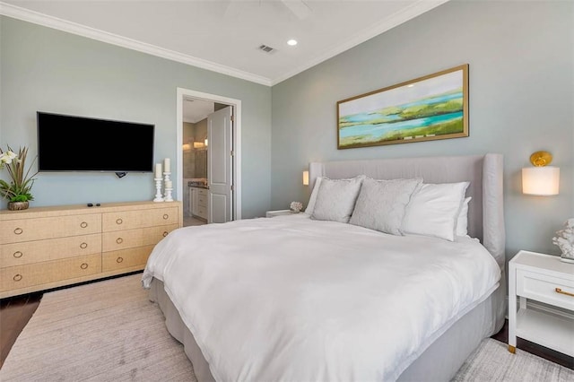 bedroom with ensuite bath, ceiling fan, hardwood / wood-style floors, and ornamental molding