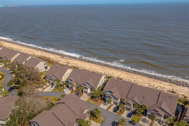 drone / aerial view with a water view and a beach view