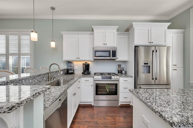 kitchen featuring sink, decorative light fixtures, dark hardwood / wood-style flooring, white cabinetry, and stainless steel appliances