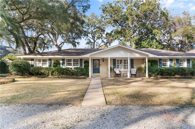 ranch-style home featuring a porch and a front lawn