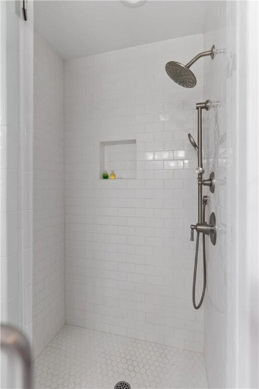 bathroom with tiled shower