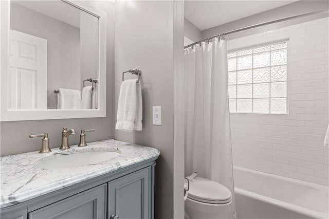 full bathroom featuring toilet, vanity, and shower / bathtub combination with curtain