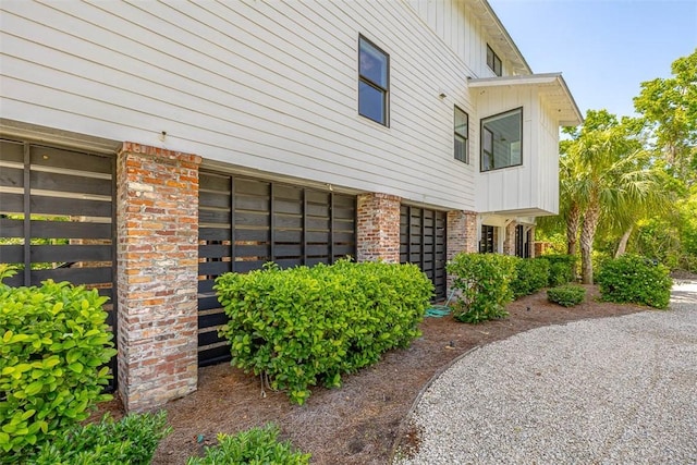 10 Fern Ln, Saint Simons Island, GA 31522 - view of property exterior with brick siding and board and batten siding