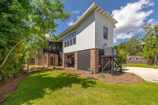 10 Fern Ln, Saint Simons Island, GA 31522 - back of property featuring stairway and brick siding
