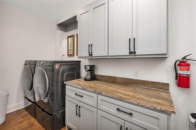 10 Fern Ln, Saint Simons Island, GA 31522 - washroom featuring independent washer and dryer, cabinet space, and dark wood-style flooring