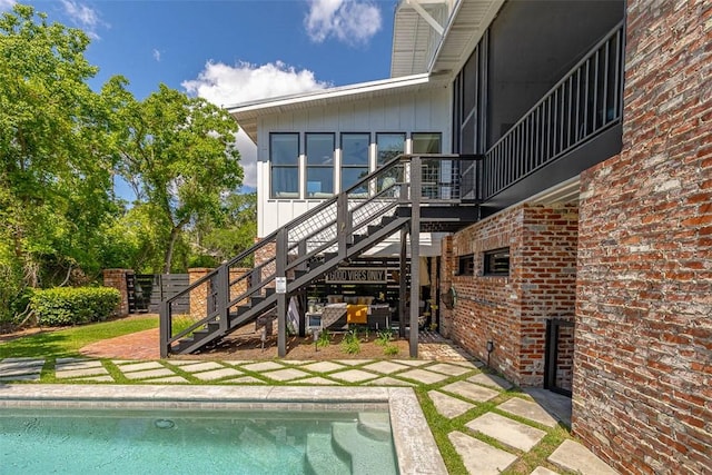 10 Fern Ln, Saint Simons Island, GA 31522 - rear view of property with stairway, a patio, and brick siding