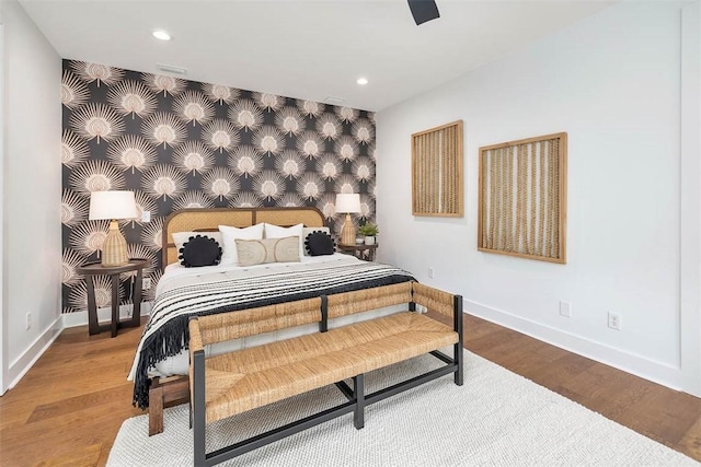 10 Fern Ln, Saint Simons Island, GA 31522 - bedroom featuring an accent wall, wallpapered walls, recessed lighting, wood finished floors, and a ceiling fan