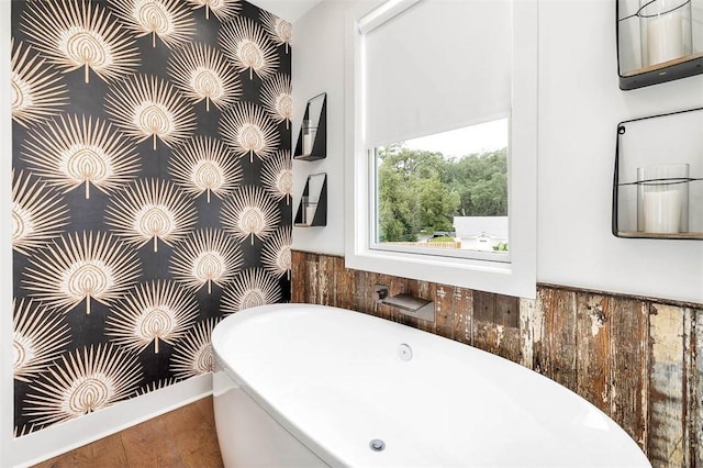 10 Fern Ln, Saint Simons Island, GA 31522 - full bath featuring a freestanding tub and wood finished floors