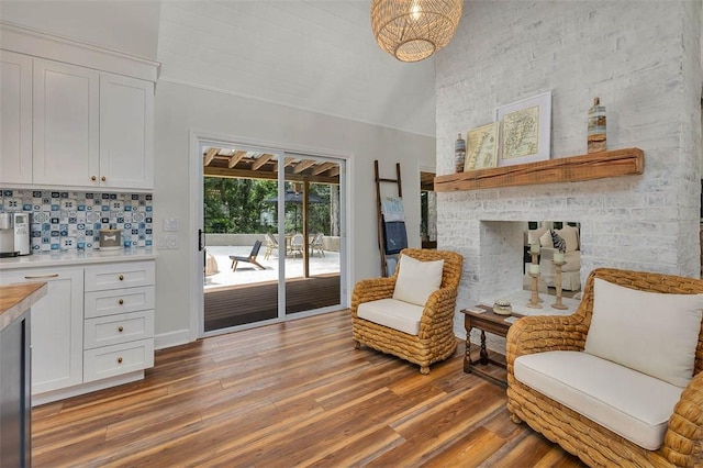 19 Wimbledon Ct, Saint Simons Island, GA 31522 - sitting room with a towering ceiling, light wood finished floors, and a multi sided fireplace