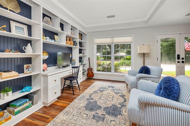 19 Wimbledon Ct, Saint Simons Island, GA 31522 - home office featuring dark wood-style flooring, plenty of natural light, built in desk, french doors, and ornamental molding