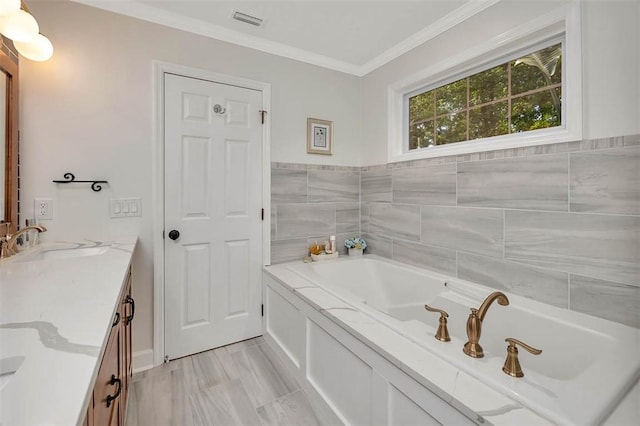 19 Wimbledon Ct, Saint Simons Island, GA 31522 - bathroom featuring vanity, a garden tub, and ornamental molding