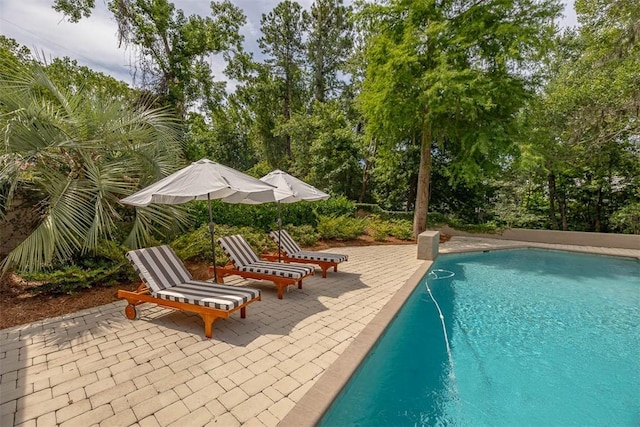 19 Wimbledon Ct, Saint Simons Island, GA 31522 - outdoor pool with a patio area and view of scattered trees