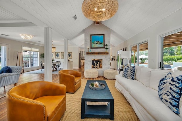 19 Wimbledon Ct, Saint Simons Island, GA 31522 - living room with a brick fireplace, wood finished floors, and lofted ceiling