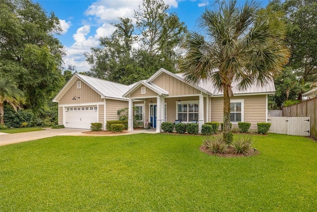 606 Shore Edge Trce, Saint Simons Island, GA 31522 - view of front facade featuring board and batten siding, a garage, driveway, and a porch