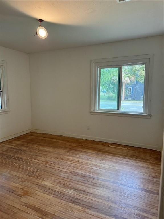 spare room with light hardwood / wood-style flooring