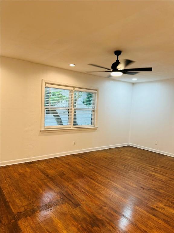 unfurnished room with ceiling fan and dark hardwood / wood-style floors