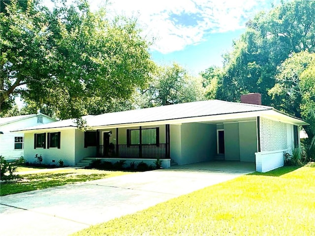 single story home with a carport, covered porch, and a front yard