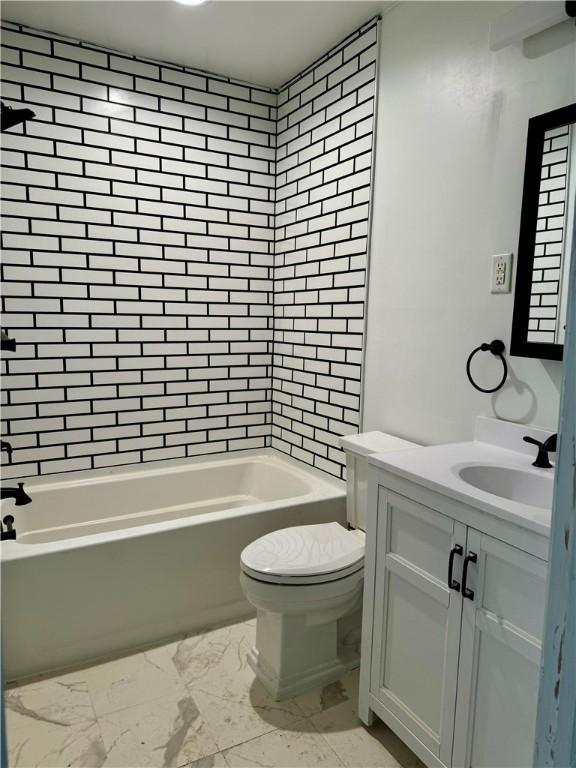 full bathroom with vanity, toilet, and tiled shower / bath