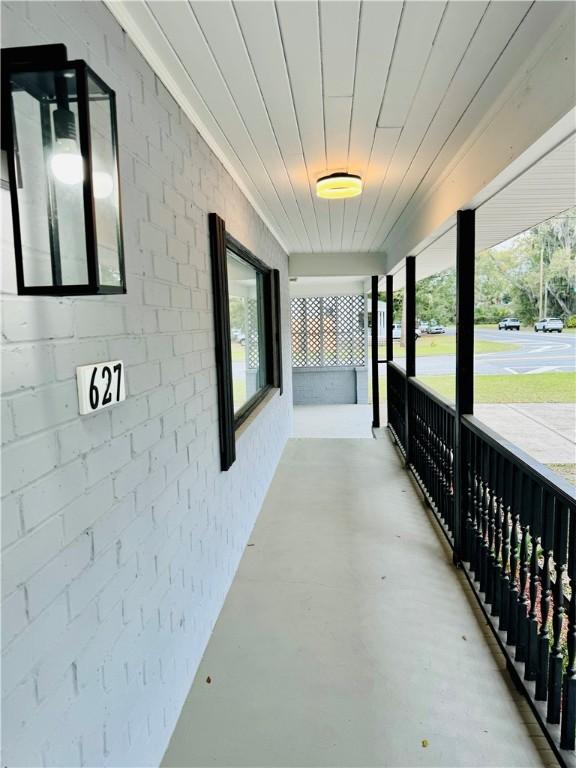 hallway featuring brick wall