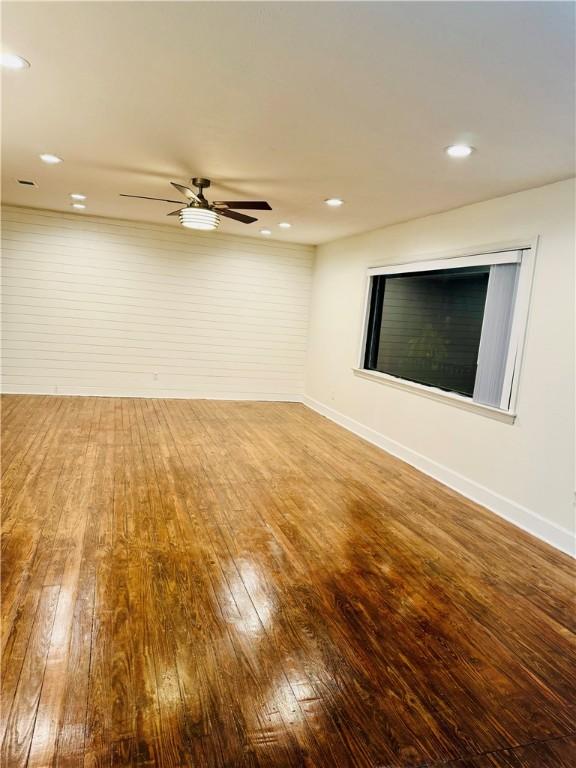 spare room with hardwood / wood-style flooring and ceiling fan