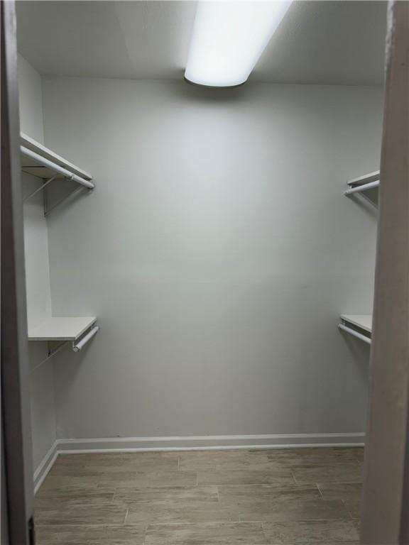 walk in closet featuring hardwood / wood-style floors