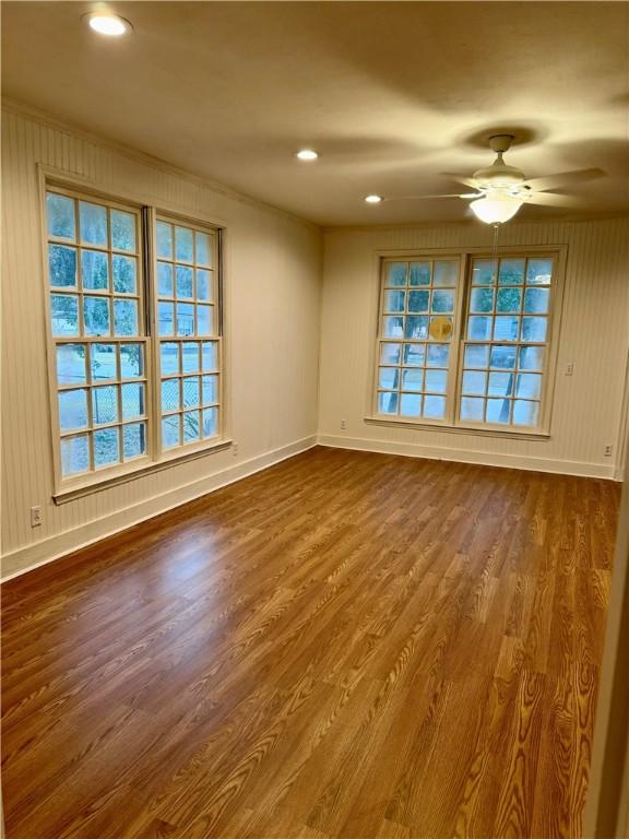 unfurnished room with ceiling fan and wood-type flooring