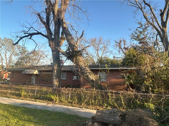 view of front of house with a fenced front yard and brick siding