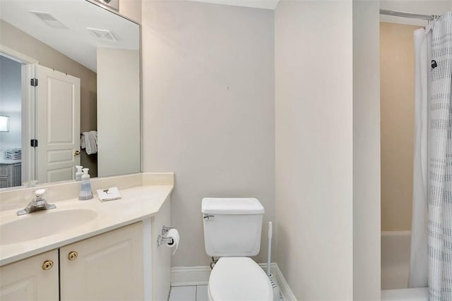 bathroom featuring tile patterned flooring, vanity, and toilet