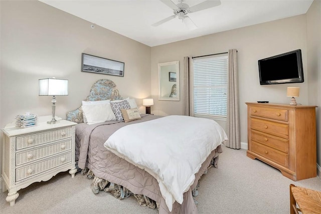 bedroom with ceiling fan and light colored carpet