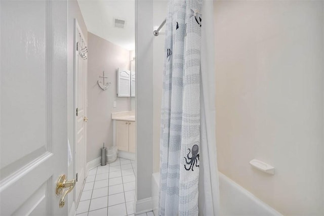 bathroom with tile patterned flooring, vanity, and shower / tub combo