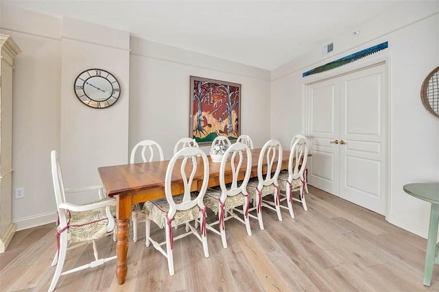 dining space with light hardwood / wood-style floors