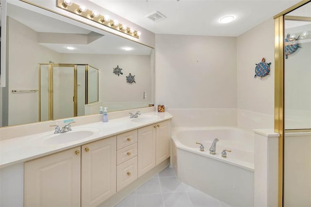 bathroom featuring vanity, shower with separate bathtub, and tile patterned floors