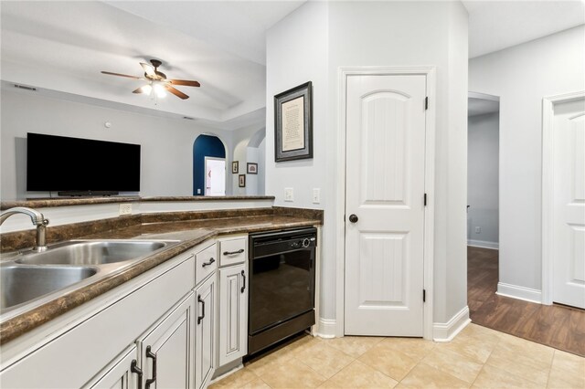 kitchen featuring dark countertops, light tile patterned floors, visible vents, and dishwasher