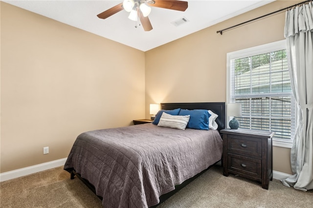 bedroom featuring a ceiling fan, light colored carpet, visible vents, and baseboards