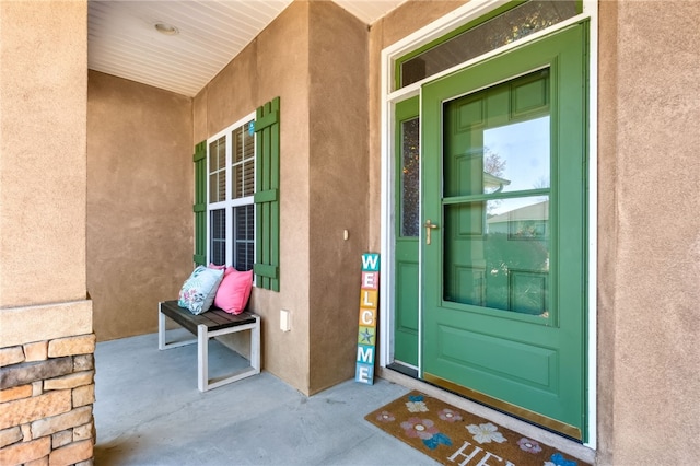 property entrance with stucco siding