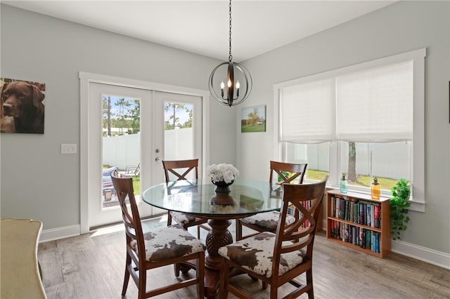 1616 Ashantilly Dr, Darien, GA 31305 - dining room featuring light wood-style flooring, french doors, and a chandelier