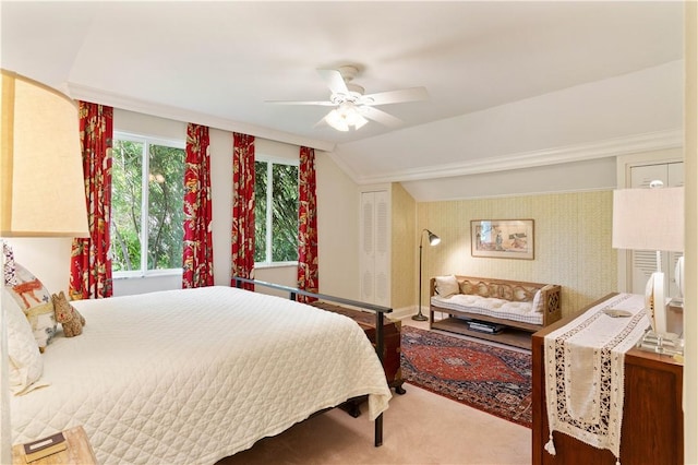 bedroom featuring a ceiling fan, lofted ceiling, a closet, and carpet flooring