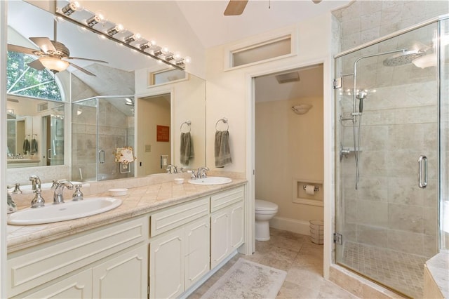 bathroom featuring lofted ceiling, a sink, a shower stall, and toilet