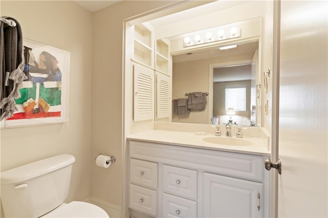 bathroom with toilet and vanity