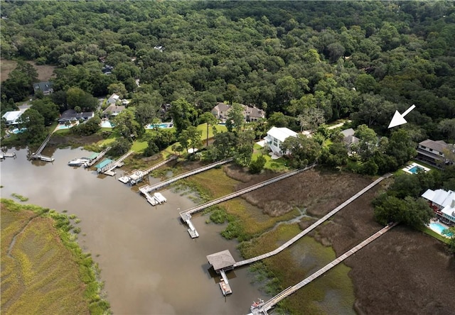 drone / aerial view featuring a forest view and a water view