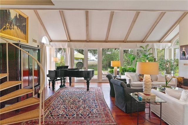 living room with stairway, lofted ceiling with beams, and wood finished floors