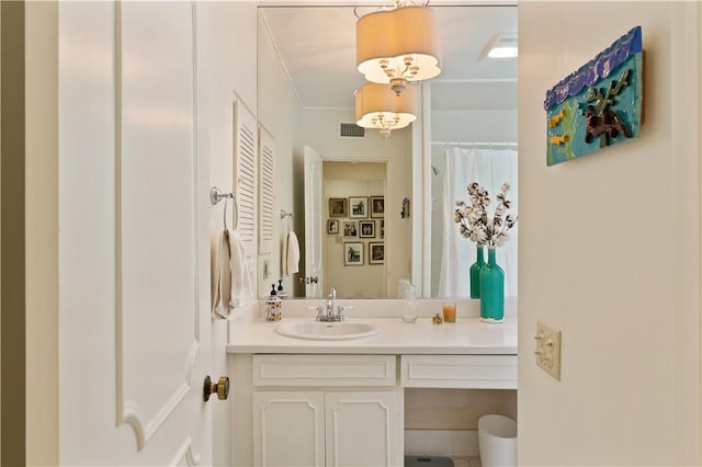 bathroom with visible vents, vanity, and crown molding