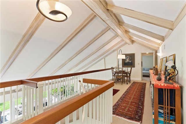 hallway with vaulted ceiling with beams