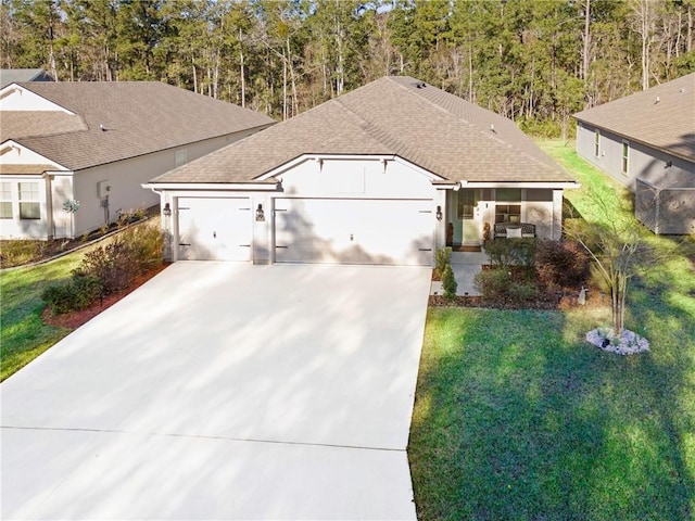 view of front of property with a front yard and a garage