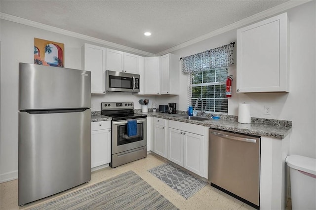 103 Travellers Way, Saint Simons Island, GA 31522 - kitchen featuring appliances with stainless steel finishes, ornamental molding, white cabinetry, a textured ceiling, and recessed lighting